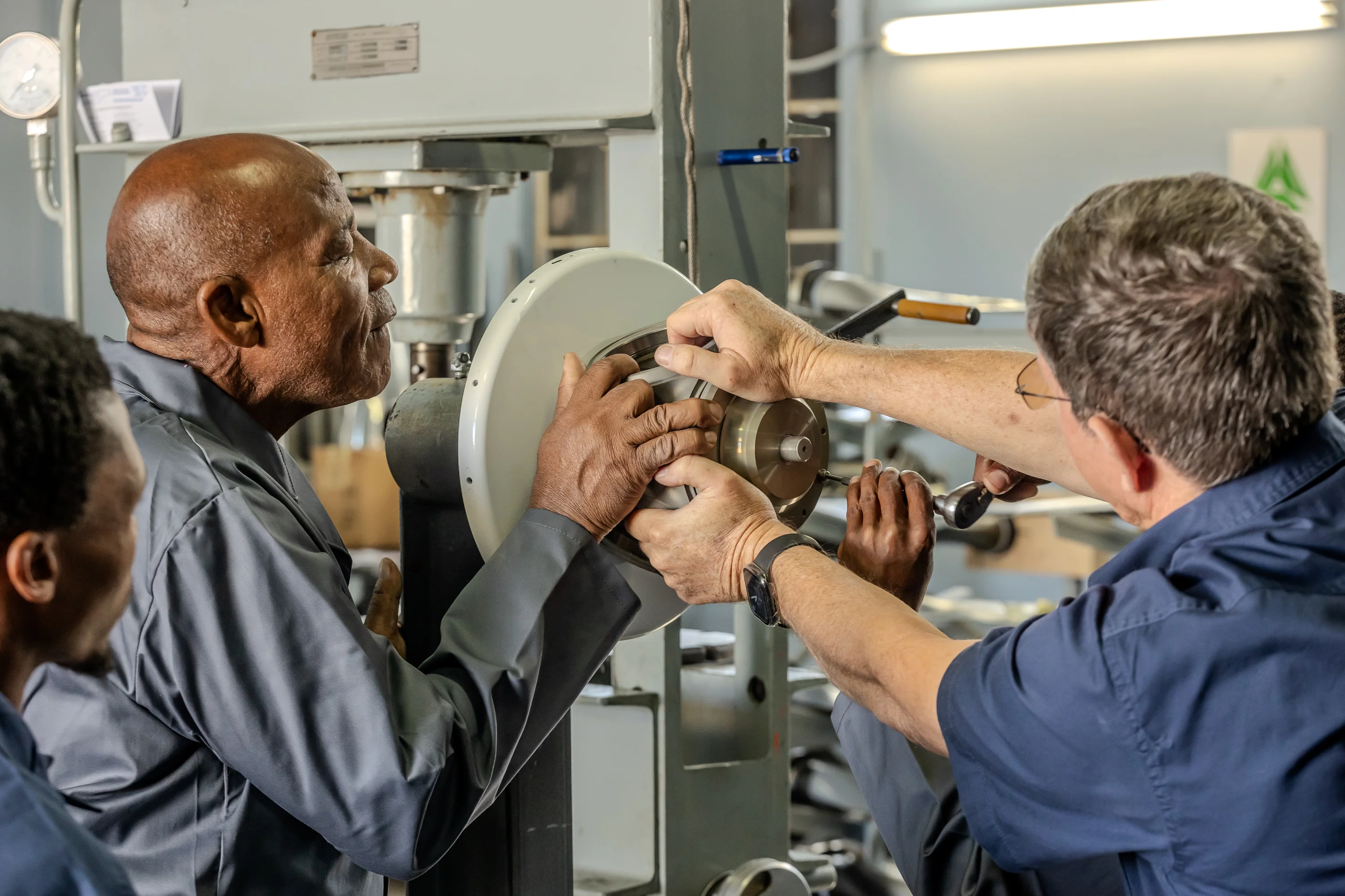 Two specialists inspecting a propeller assembly